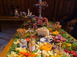 Sausages, cheese and fruit on a wooden table