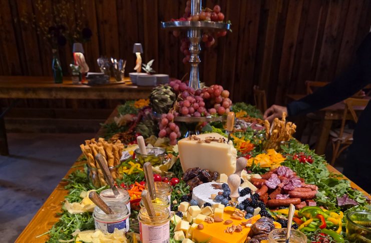 Sausages, cheese and fruit on a wooden table