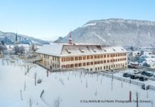 A culinary retreat in Stans, Switzerland Imposing monastery building in a snowy landscape, low mountains behind