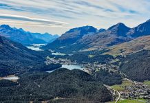 Sweeping alpine vista, with a chain of lakes shimmering between gentle slopes